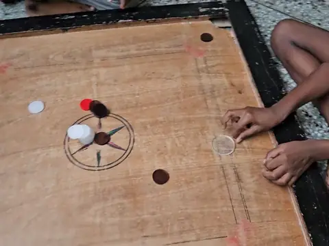 Boys playing carrom at the hostel