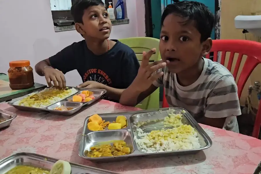 Boys eating a vegetarian thali