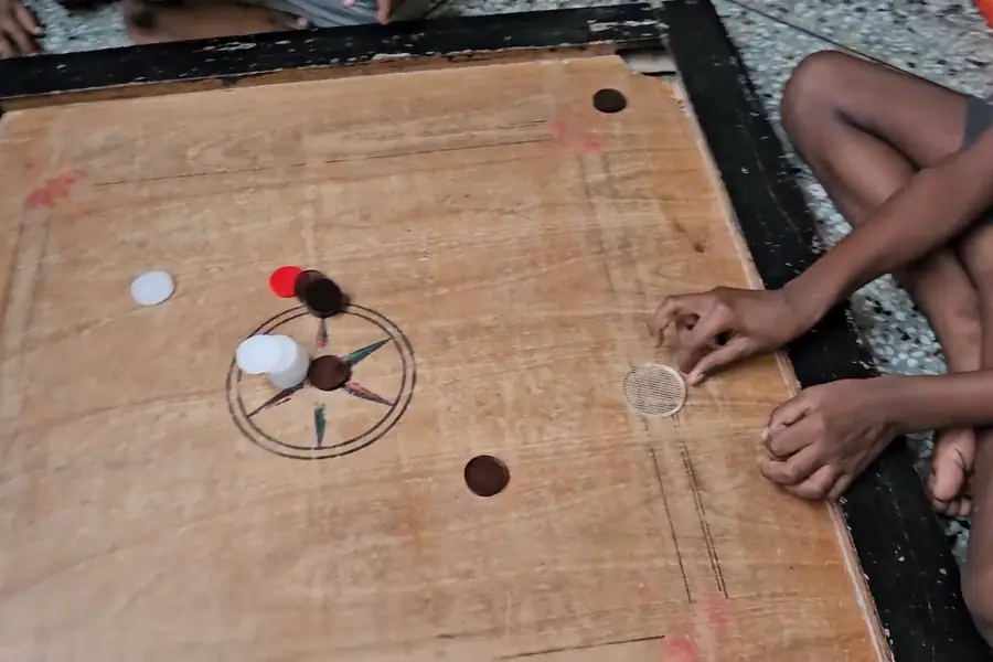 Boys playing carrom