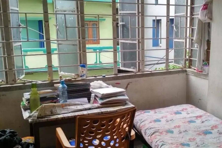 Bed and study table in a hostel room