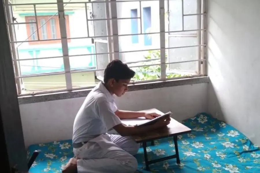 Student studying by the window
