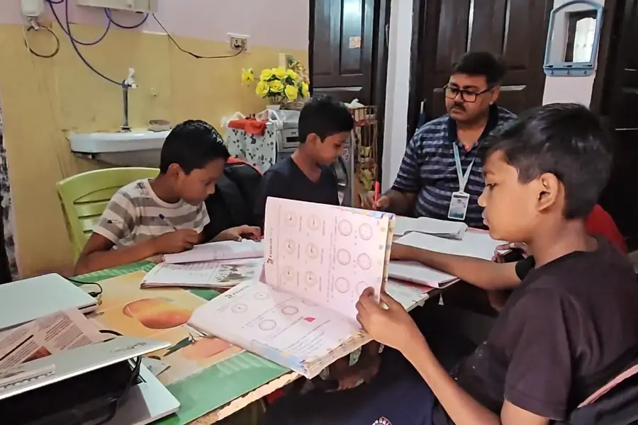 Tutor teaching junior students